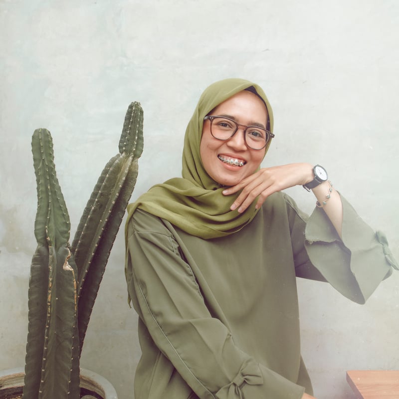 Portrait of a Young Woman near Cactus Plant